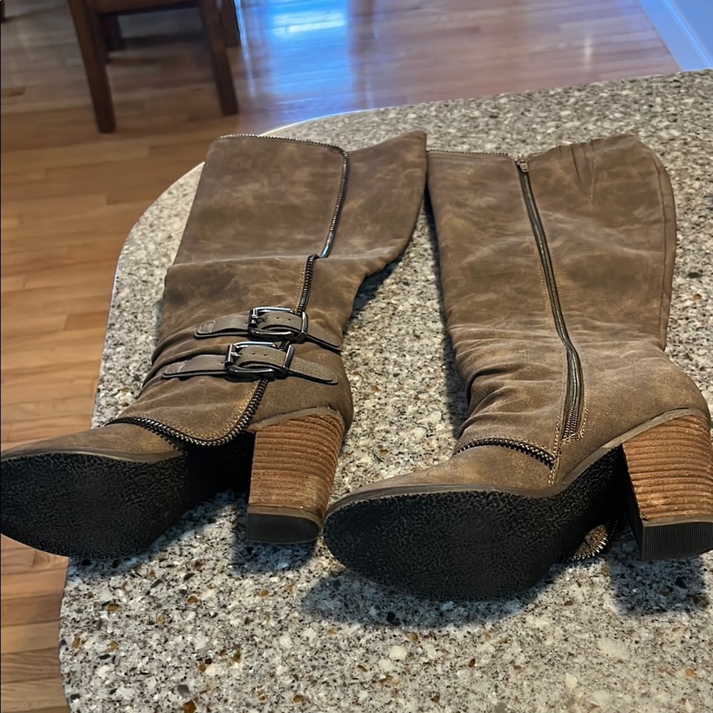 Not yet Rated- high heel boot is with zipper details.